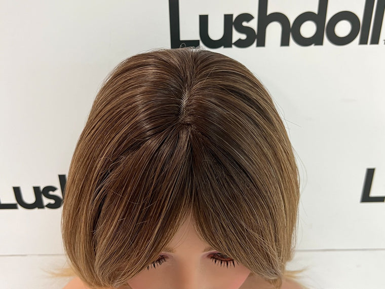 Synthetic sex doll wig being styled